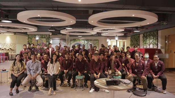 Group photo in a modern lounge with circular ceiling lights
